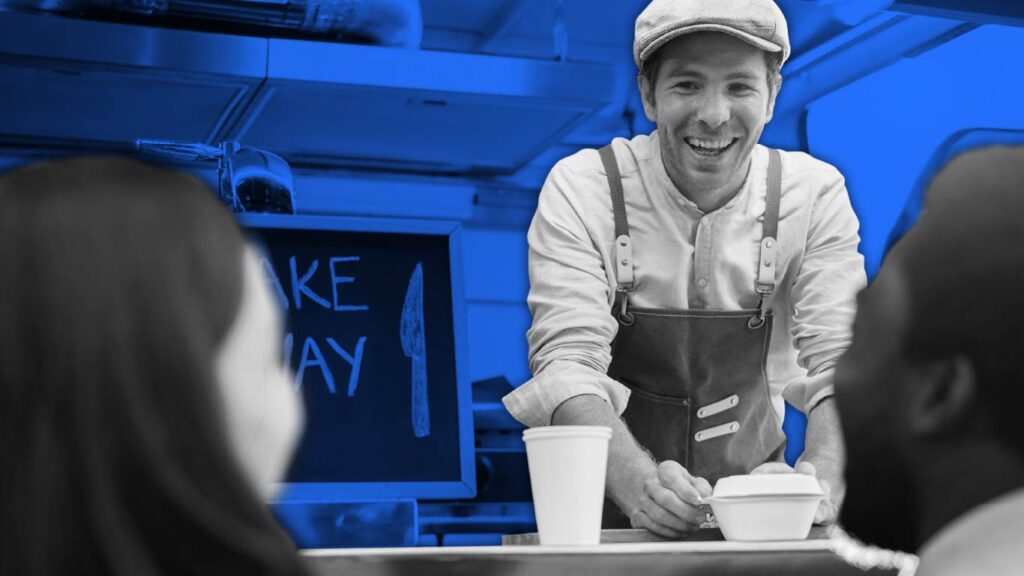 Black and white photograph of man handing food to two customers through a food truck window, with blue background.