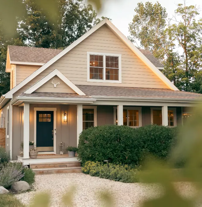 craftsman house front porch blue door dusk