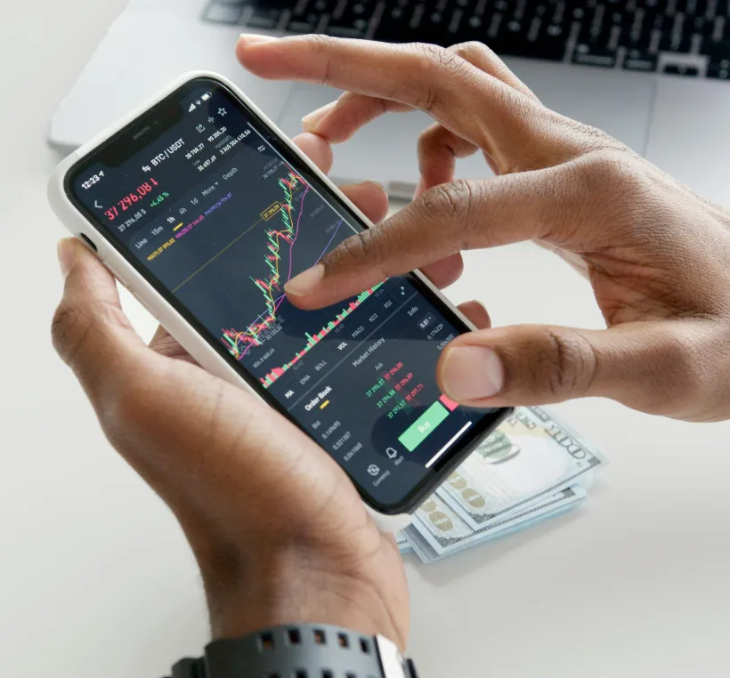 hands using smartphone crypto trading app candlestick chart